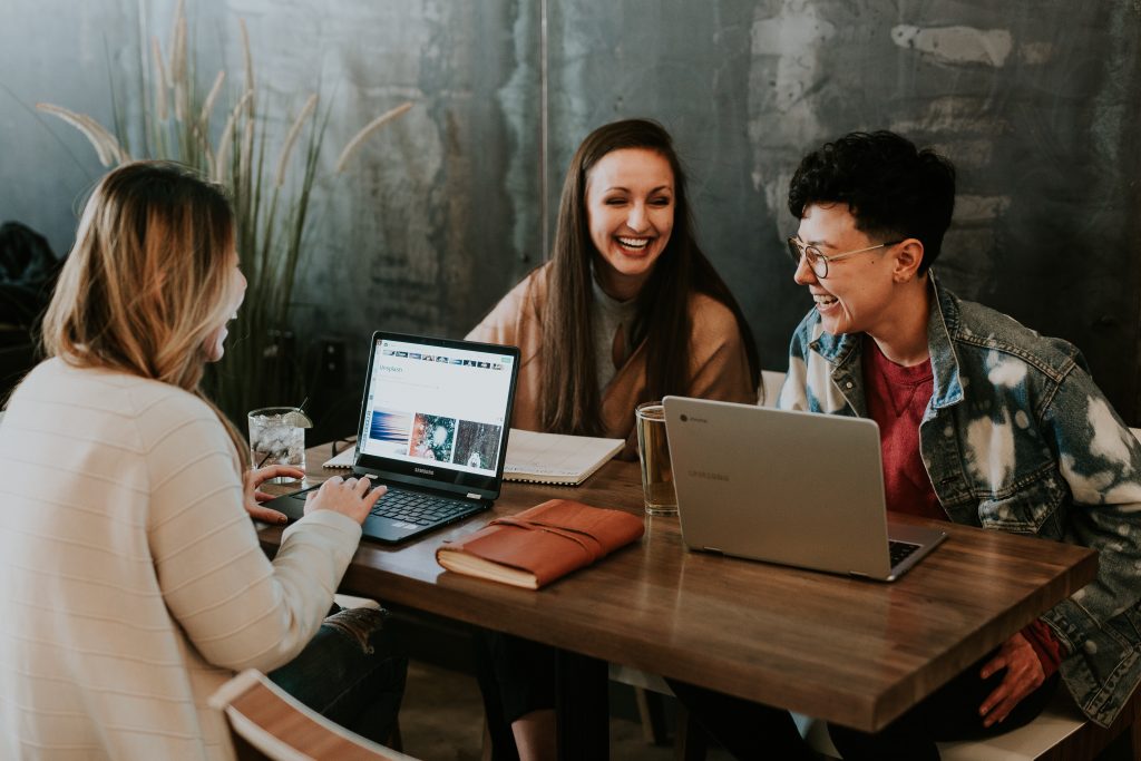 young people on their laptop smiling