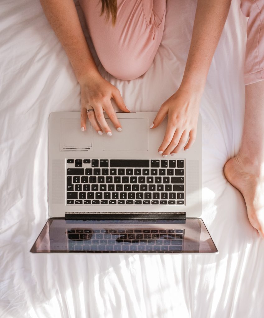 girl in bed on laptop