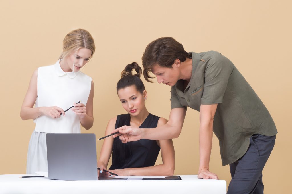 man-an-two-women-working-on-laptop